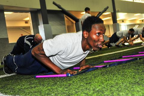 A man does a pushup as part of an exercise class.