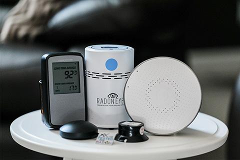 Radon testing devices arranged on a table