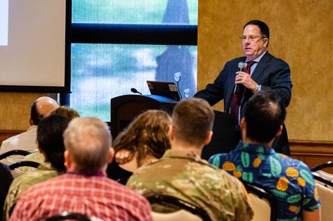 Photo of keynote speaker Dr. Robert "Chip" Schooley addressing a large audience at the festival