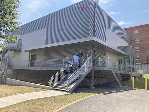 Photo of a group of people standing in front of a building