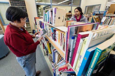 woman browsing books on a shelf
