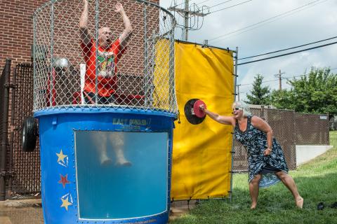 Man being dunked in dunk tank.