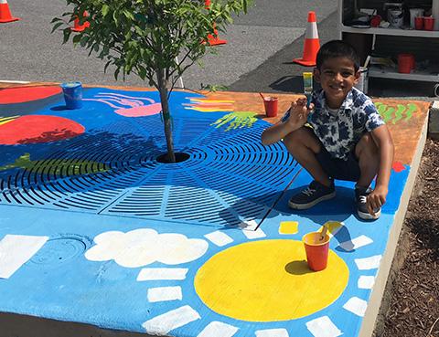 Photo of Vihann Patel with his winning "Paint the Drain" design