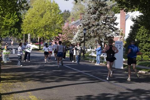 Festival staff hand out water at the 12th mile marker during the Frederick Running Festival.
