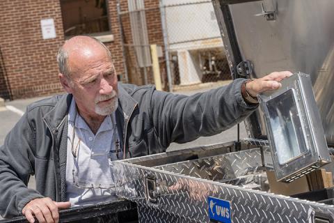 Doug Vaughn removes a trap from his truck