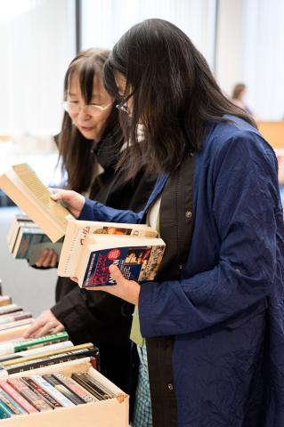 Two women look through the books at the 2016 Book and Media Swap.