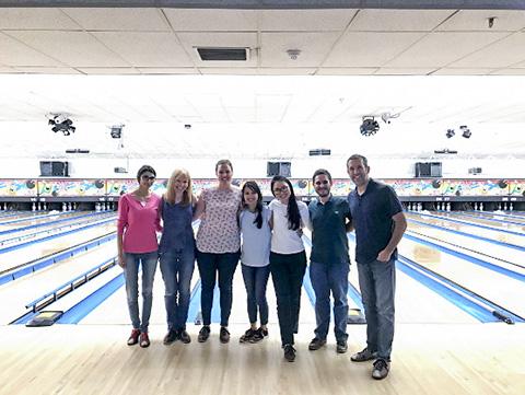 A team photo of some of John Brognard's laboratory members at a bowling alley.