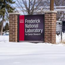 The Frederick National Laboratory sign surrounded by snow