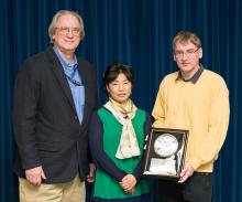 Three scientists at award presentation.