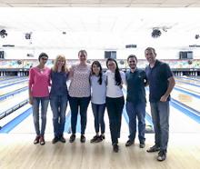 A team photo of some of John Brognard's laboratory members at a bowling alley.