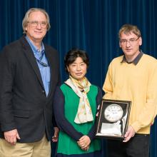 Three scientists at award presentation.