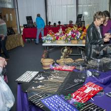 Employees browsing vendor tables at Holiday Market