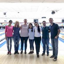 A team photo of some of John Brognard's laboratory members at a bowling alley.
