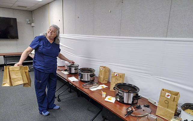 The final tally begins. OHS Manager Sarah Hooper collects the bags into which employees cast their votes.