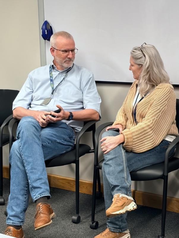 Dan McVicar (left) and Mary Kearney (right) enjoy the potluck event and share a conversation before giving their remarks to the fellows. (Image credit: Karolina Wilk)