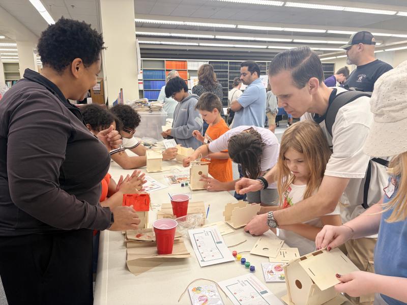 Kids and guardians alike enjoy the new build-your-own-birdhouse activity this year, meant to inspire them about engineering and the natural world. Image credit: Karolina Wilk