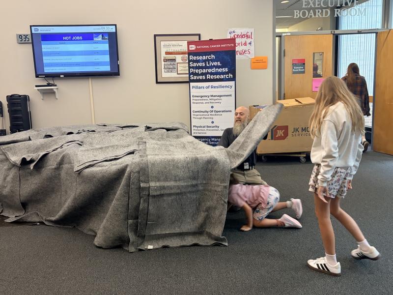 Kids line up to enter the EHS fire safety station maze, simulating finding their way through a dark, smoke-filled house to the exit. Image credit: Karolina Wilk.