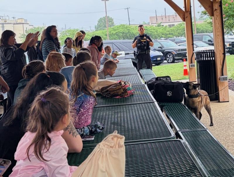 Attendees wait in suspense as one of the NIH bomb-sniffing dogs uses her nose to identify scents in various bags. Image credit: Karolina Wilk