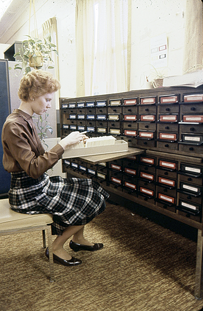 An unknown employee accesses the Scientific Library card catalog, c.1980s. (Photo from the SPGM archive.)