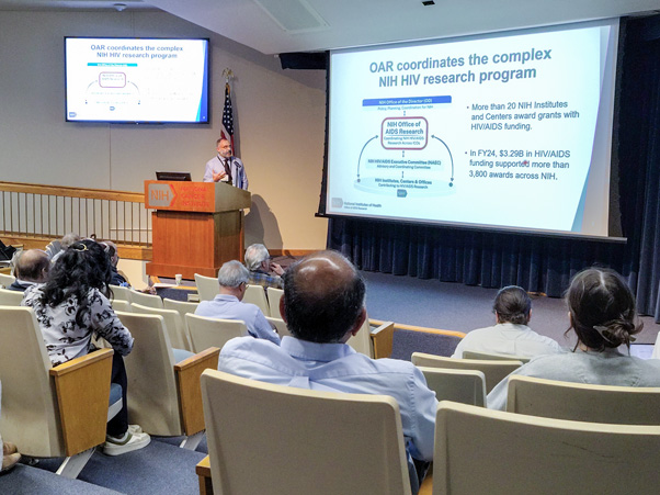 In one of the day’s more administrative presentations, Julio Aliberti, Ph.D., of the NIH Office of AIDS Research, discussed NIH policy and plans for HIV/AIDS research. (Photo by Samuel Lopez.)