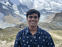 Young man with mountains in background